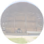 Image of a monument inside a circle, with a garden in the front