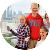 A group of four happy, young students having fun at a school trip