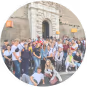 A big group of happy students in front of a building