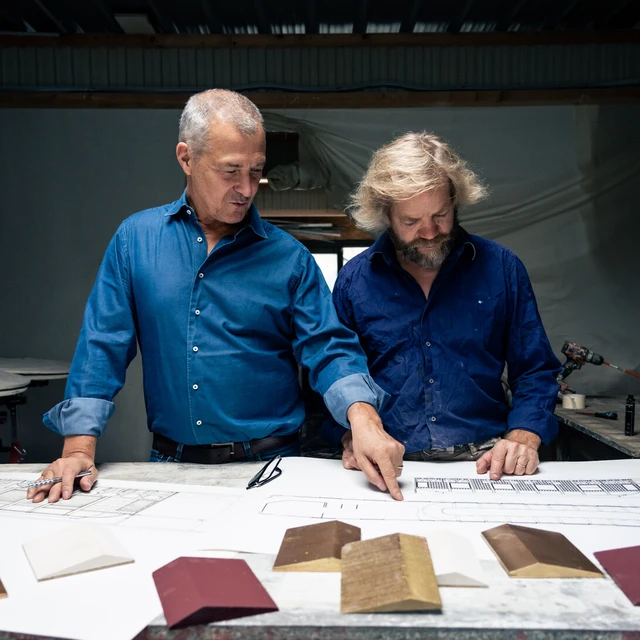 D'Angeac in conversation with D'Offard over design plans.