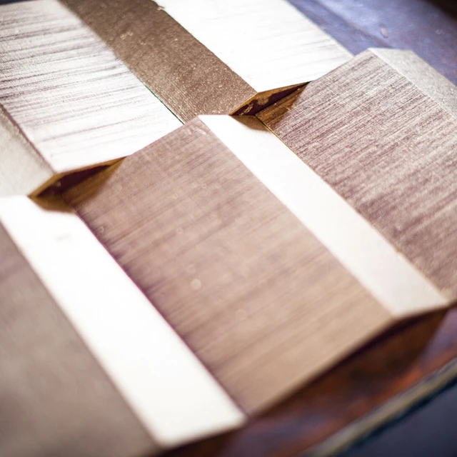 Golden wll panels laid on a table in rail-motif fashion for planning.