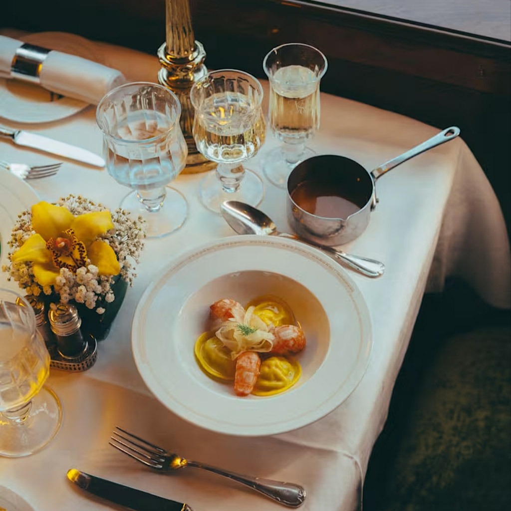 An elegantly set table of drinks and food.