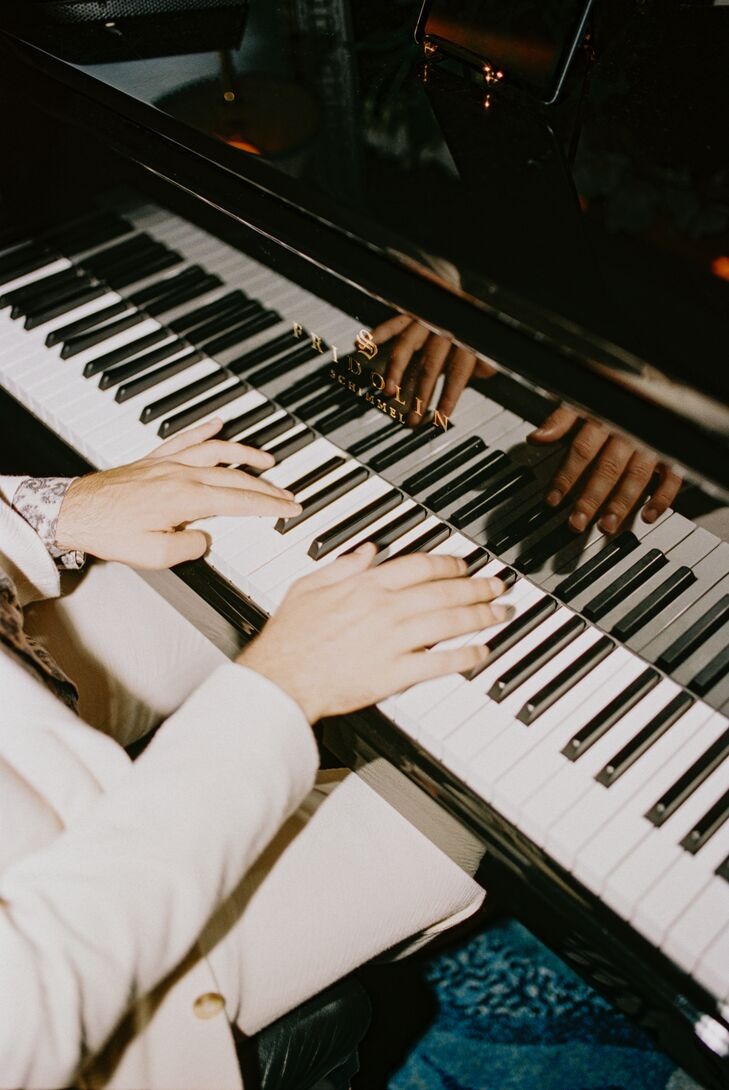 A pair of hands playing a piano.
