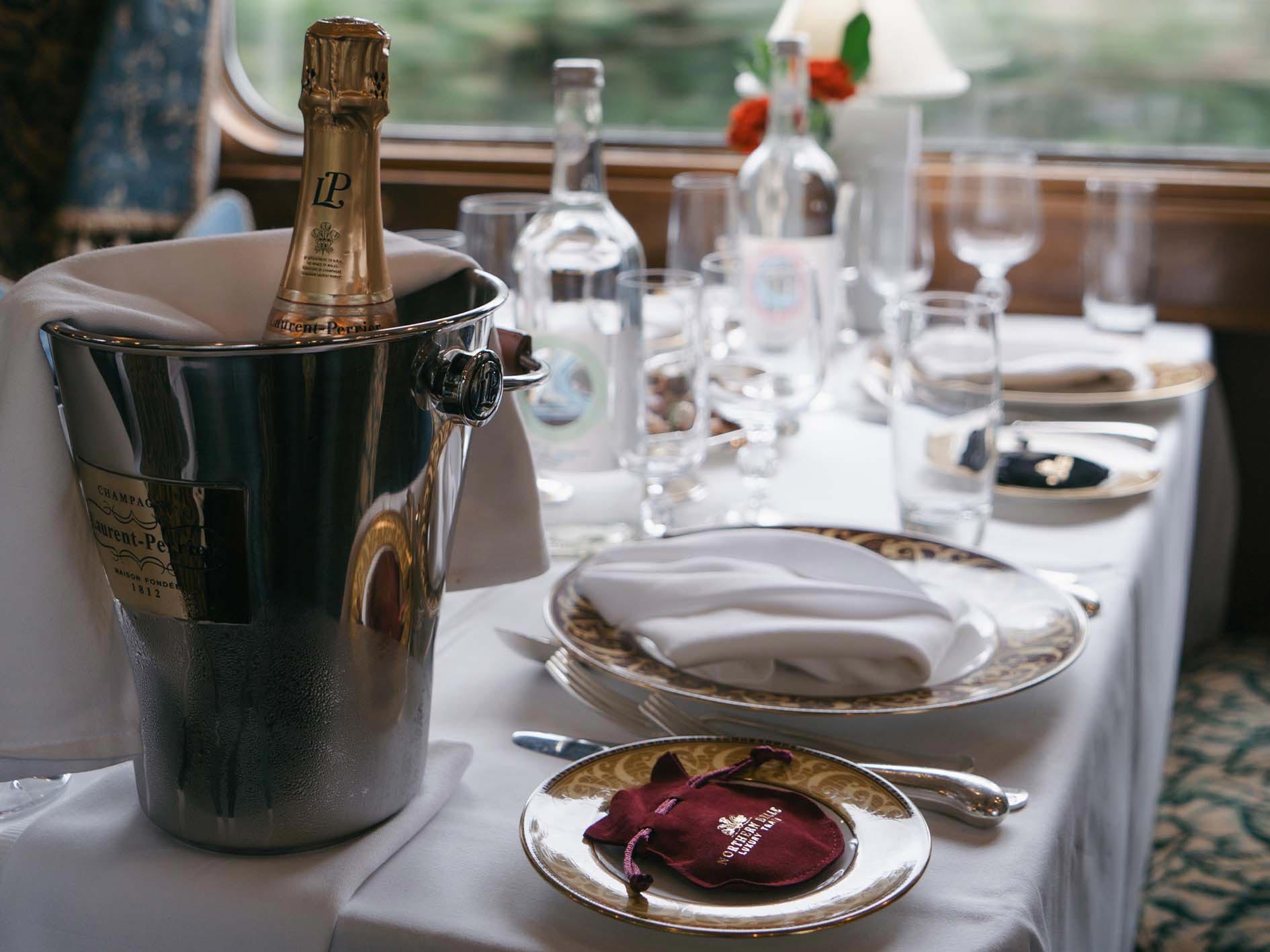 A set table on the Northern Belle with a bucket of champagne.