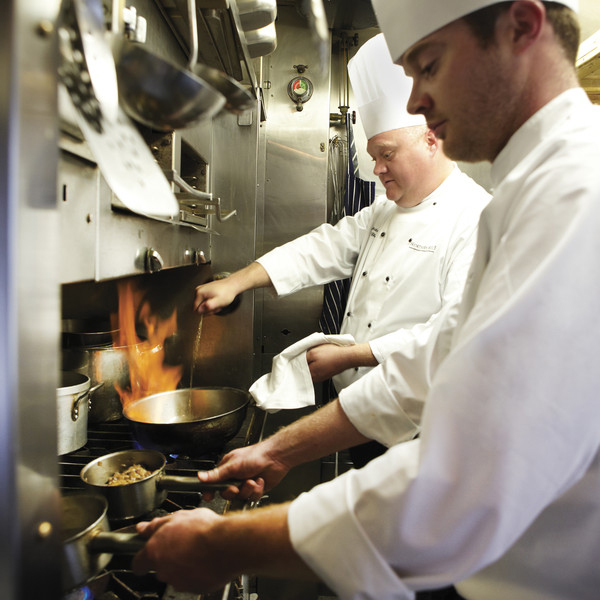 Chefs cooking in the Northern Belle kitchen.