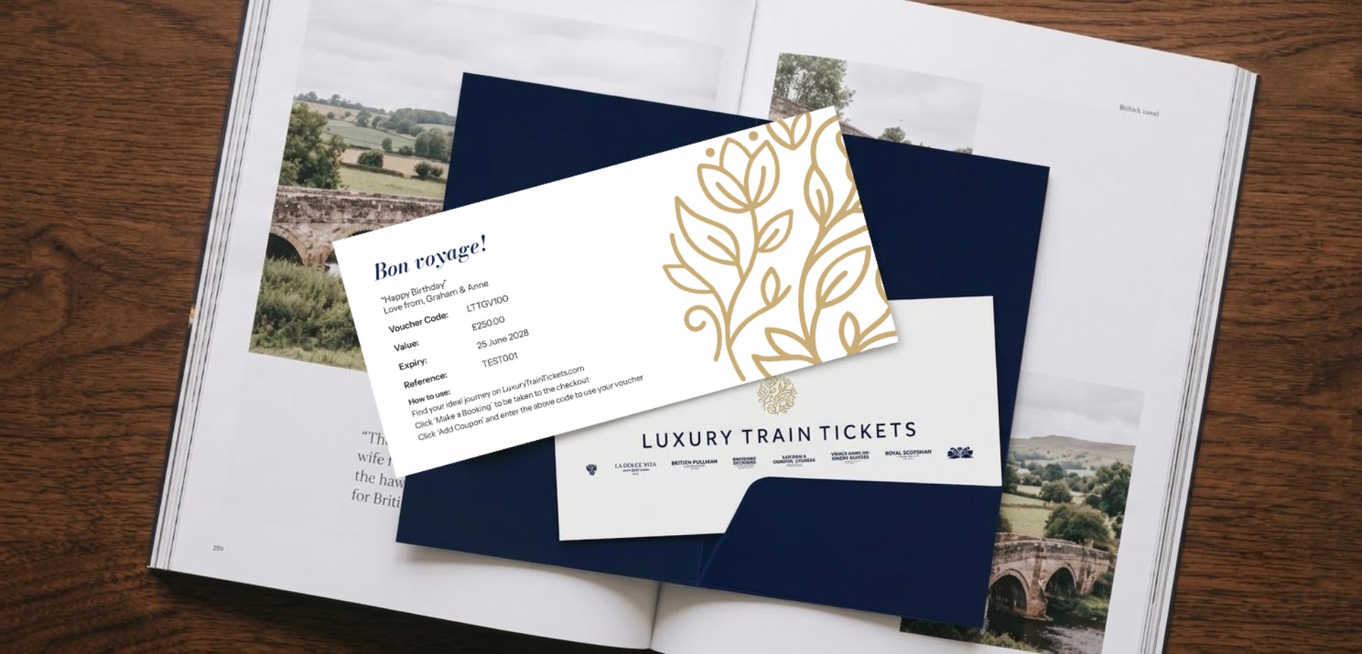 Luxury train vouchers in a card-folder, resting on a editorial magazine.