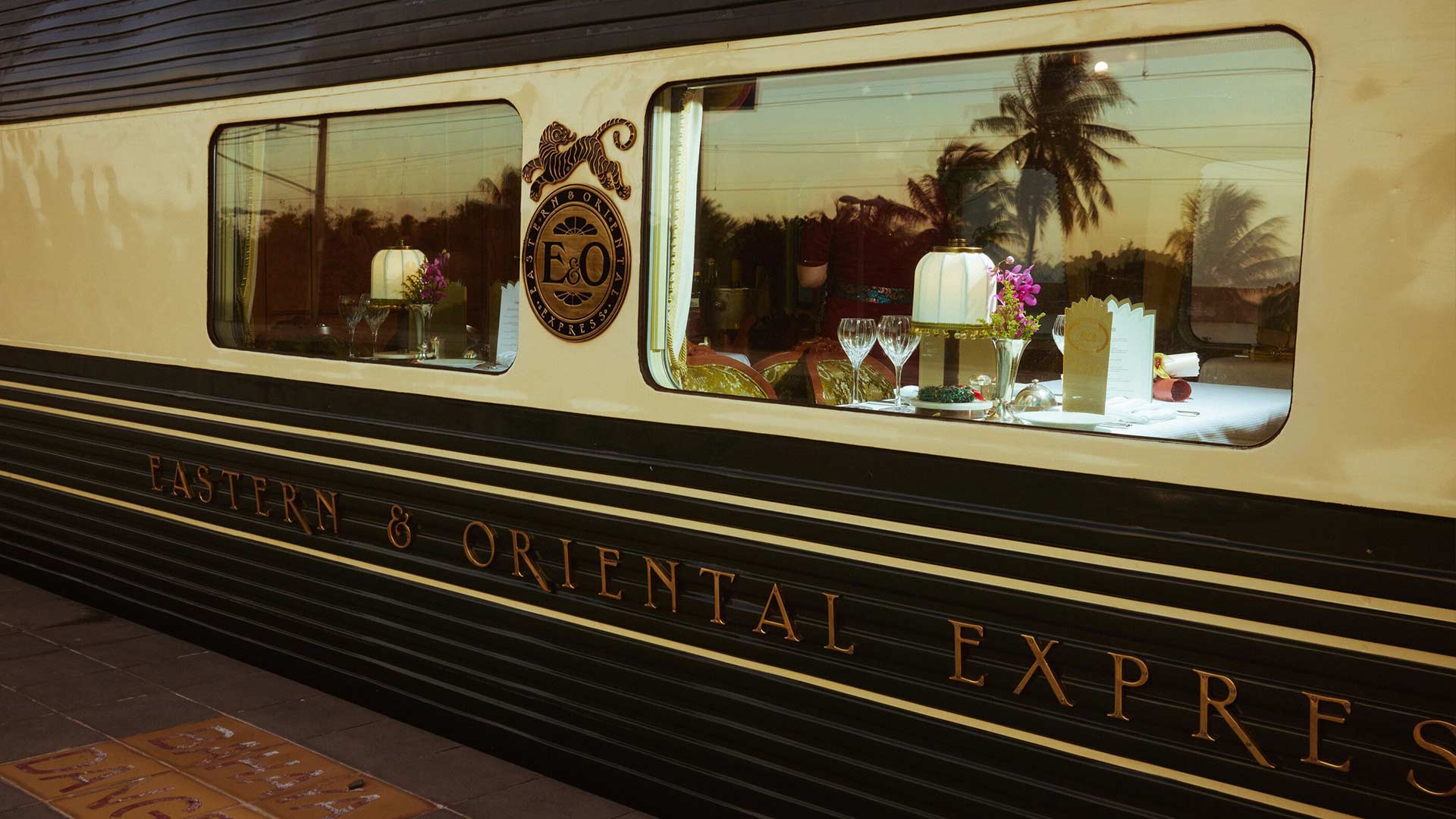 A shot of the Eastern and Oriental Express' train window, taken from a train station platform.