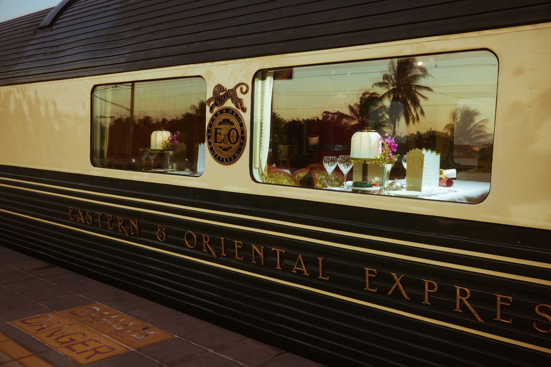 A shot of the Eastern and Oriental Express' train window, taken from a train station platform.