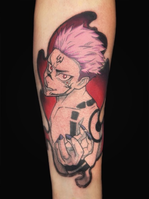 Tattoo of an anime-style character with pink spiky hair and red eyes looking back over his shoulder, extending one hand forward, with black tribal markings on his shoulder and arm on a red background, inked on a person's forearm.