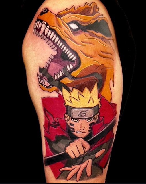 Tattoo on an arm featuring Naruto Uzumaki from the anime Naruto in red and black clothing with spiky yellow hair, headband, and focused expression, holding a kunai knife, with the fierce, roaring nine-tailed fox Kurama in orange with sharp white teeth behind him.