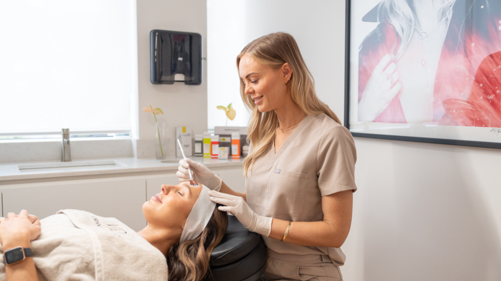 A client relaxes as the Victorian Dermal Group professional carefully conducts a chemical peel.