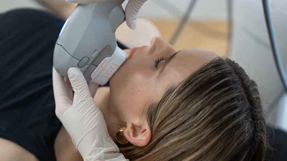 A woman undergoes a non-invasive jawline tightening treatment at Victorian Dermal Group.