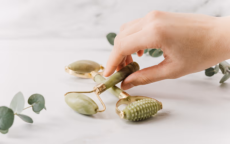person presenting massage rollers - photo by cottonboy from pexels