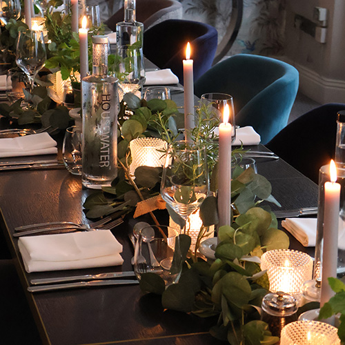 Close up of the Classic British fish and chips with home made chips and tartar sauce with mixed salad and lemon garnish.