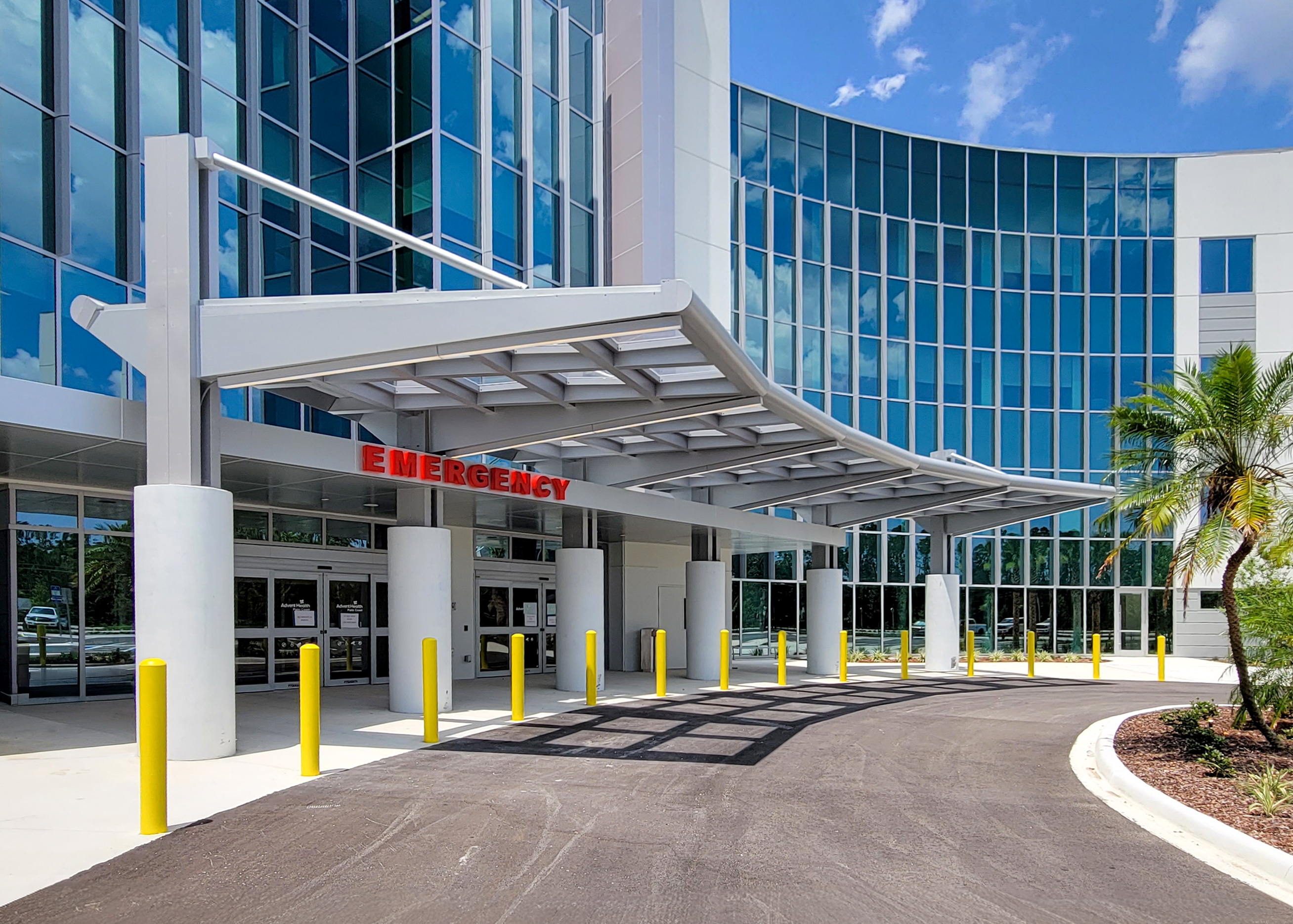 Aluminum drop-off canopy extending across the vehicle approach to the primary healthcare entrance
