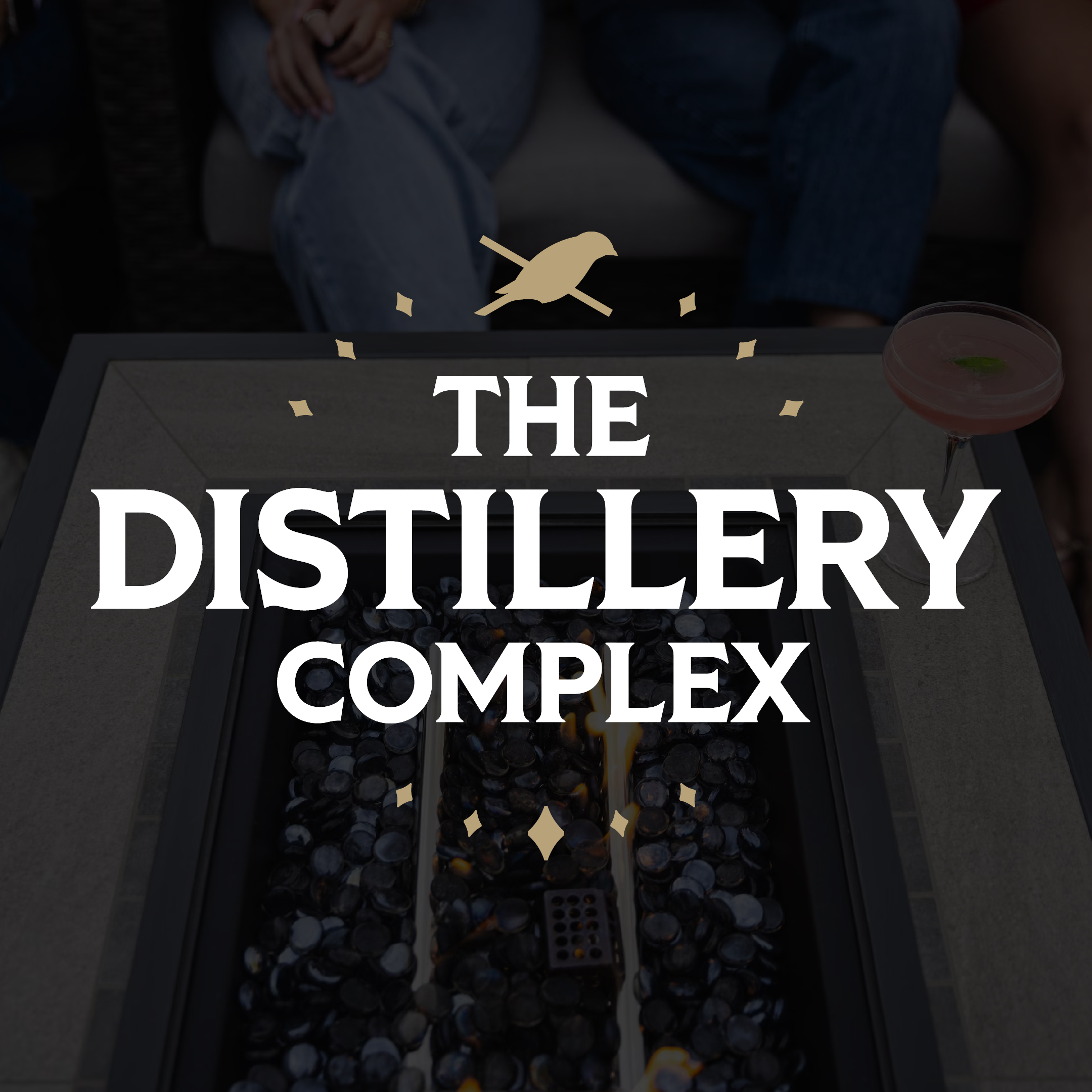 The Distillery Complex logo over outdoor firepit
