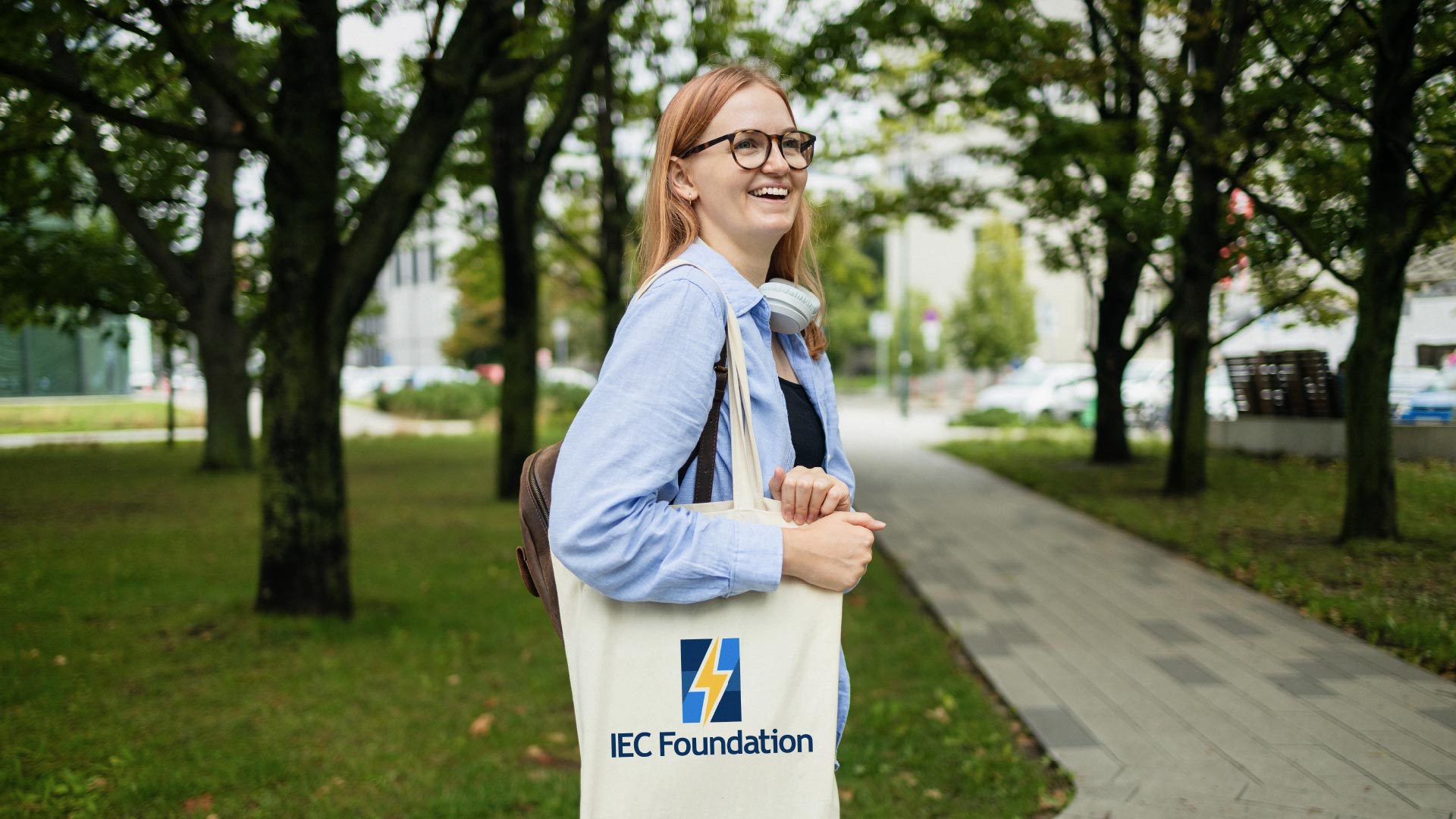 Young woman with tote mock up of new IEC Foundation logo