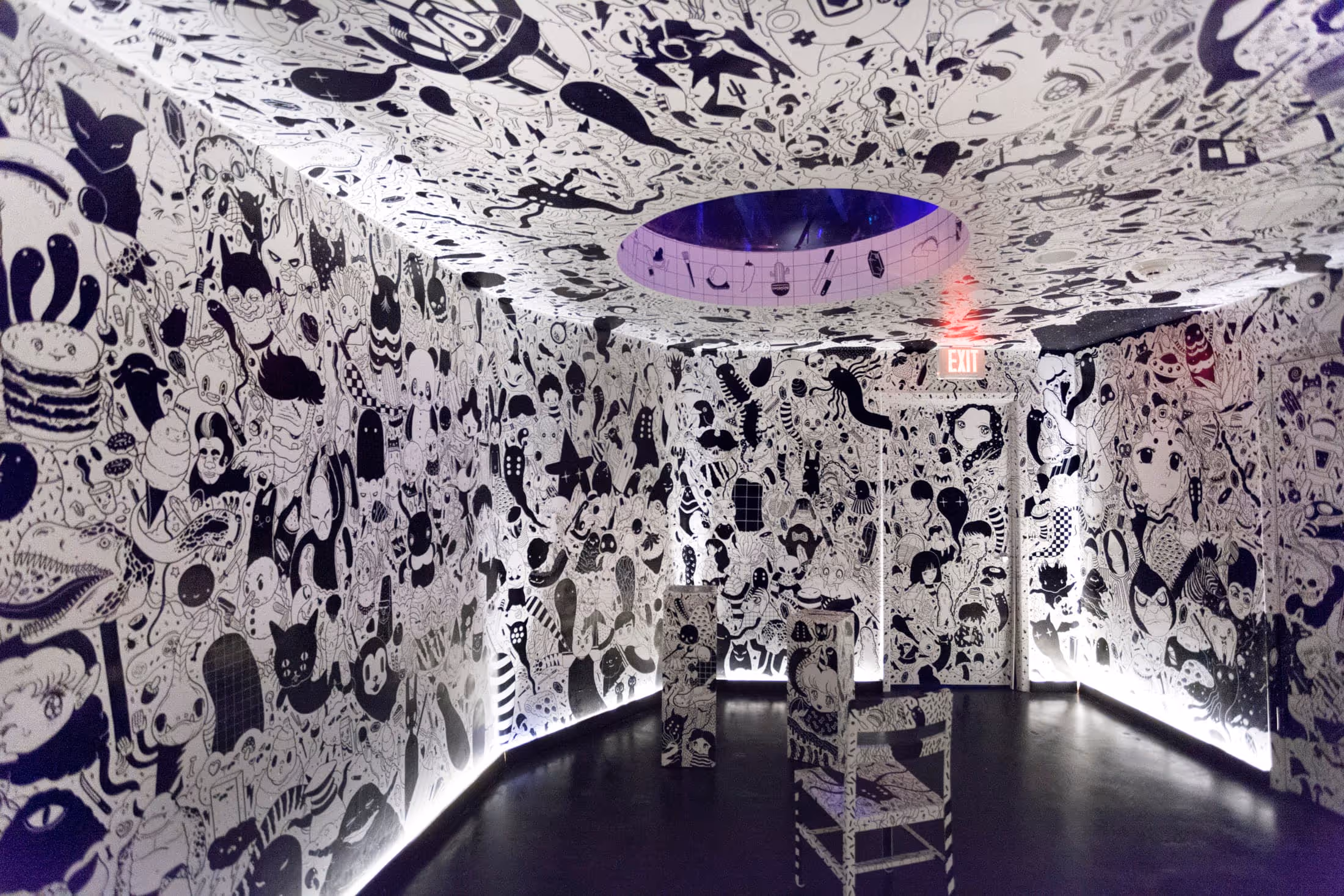 looking into a square room with black and white cartoon images by Future Fantasy Delight on every surface
