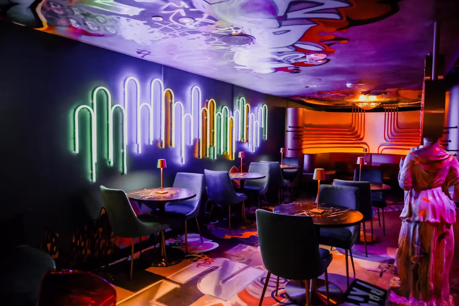 A view of a neon wave wall art on display at Sips With a Z in denver