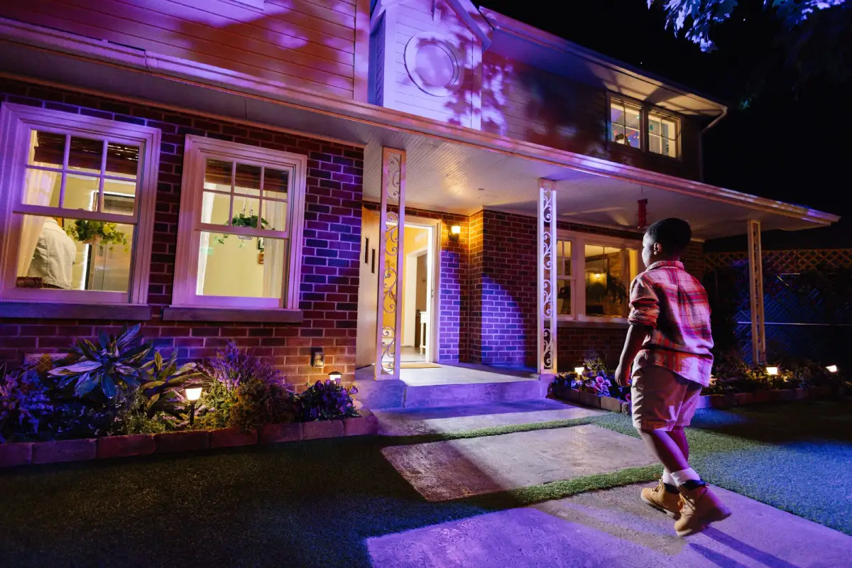 A child is walking into a house exterior at Meow Wolf Grapevine