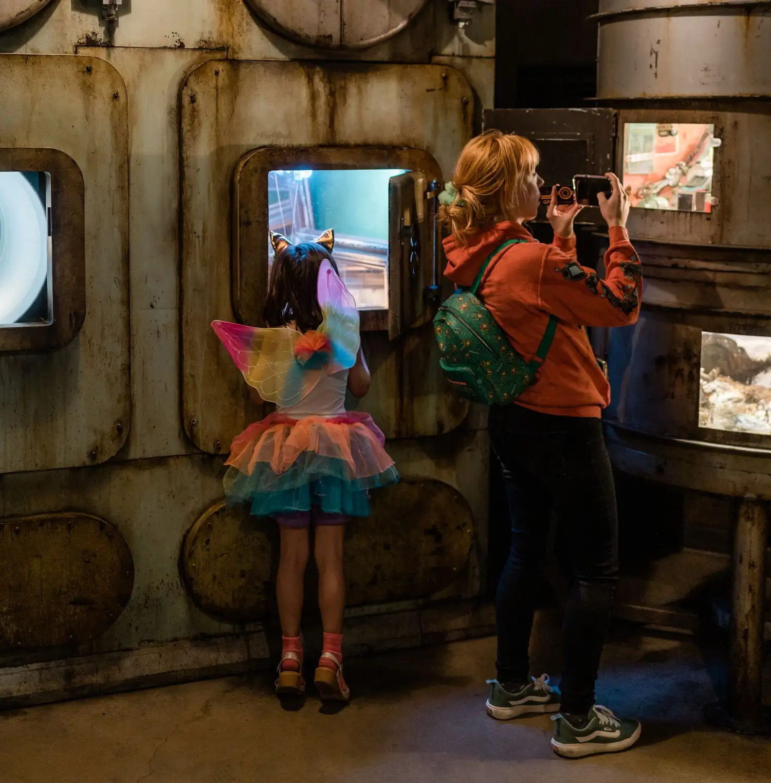 Glowing pastel Ossuary cavern with luminous columns forming a labyrinth at Meow Wolf Denver. An immersive art attraction and top group activity