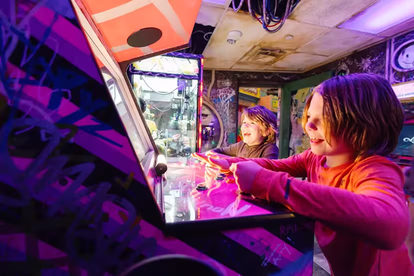 Kids playing arcade games at Meow Wolf Houston