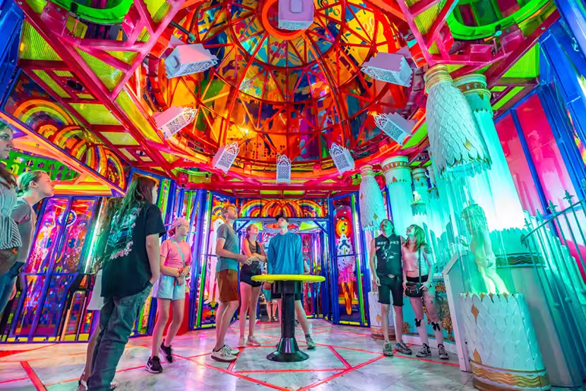 Guests enjoy a domed ceiling over a colorful room at Meow Wolf Houston