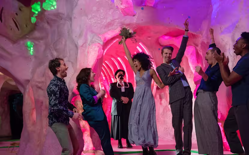 A happy couple celebrates their elopement ceremony at Meow Wolf Santa Fe