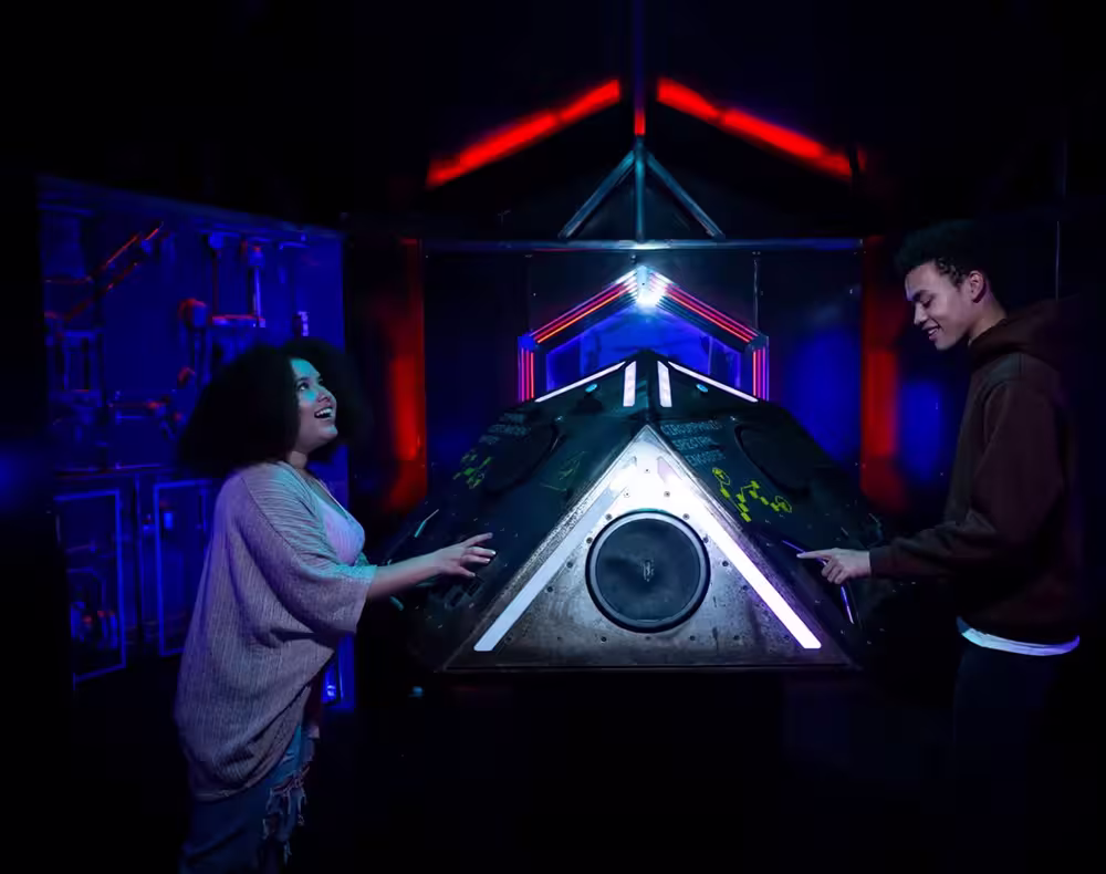 Two guests enjoying an interactive sculpture at Meow Wolf Omega Mart