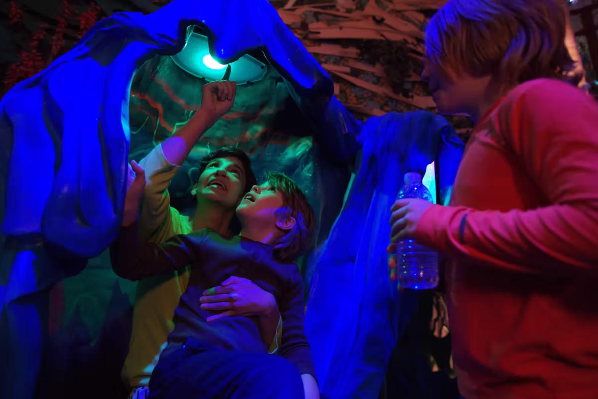 Guests inside an immersive sculpture looking at a light at The Real Unreal.