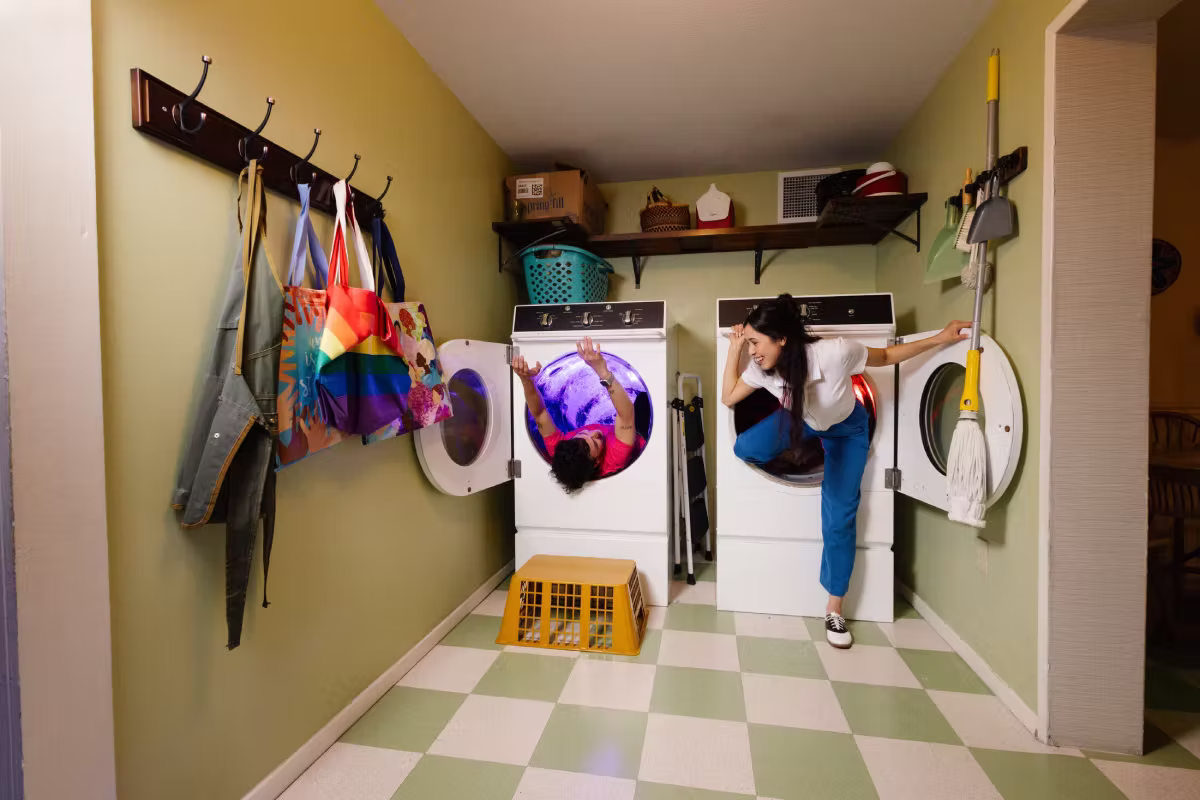 Two people coming out of a washer and dryer at Meow Wolf Grapevine.