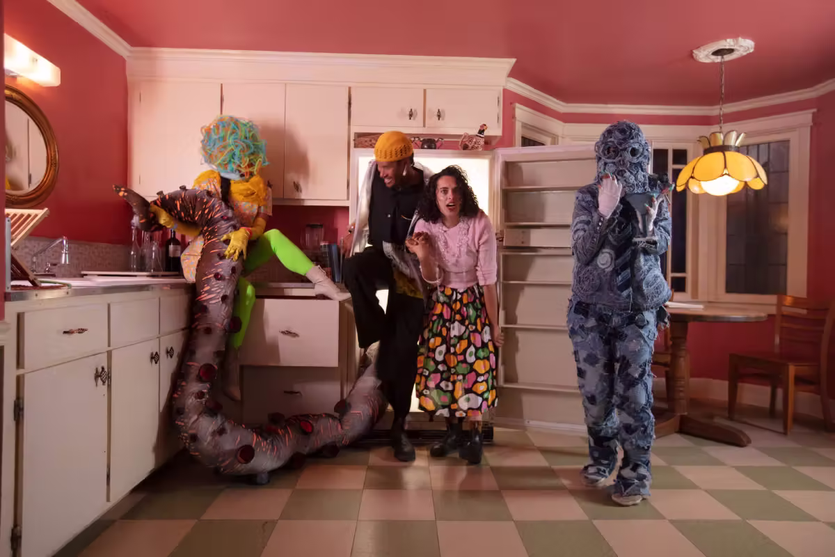 A group of people emerging from a refrigerator at Meow Wolf Santa Fe.