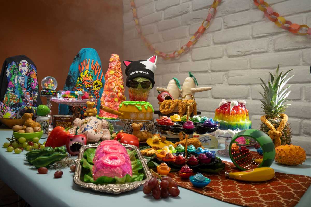 A table covered with various sculpted food pieces and merch items.