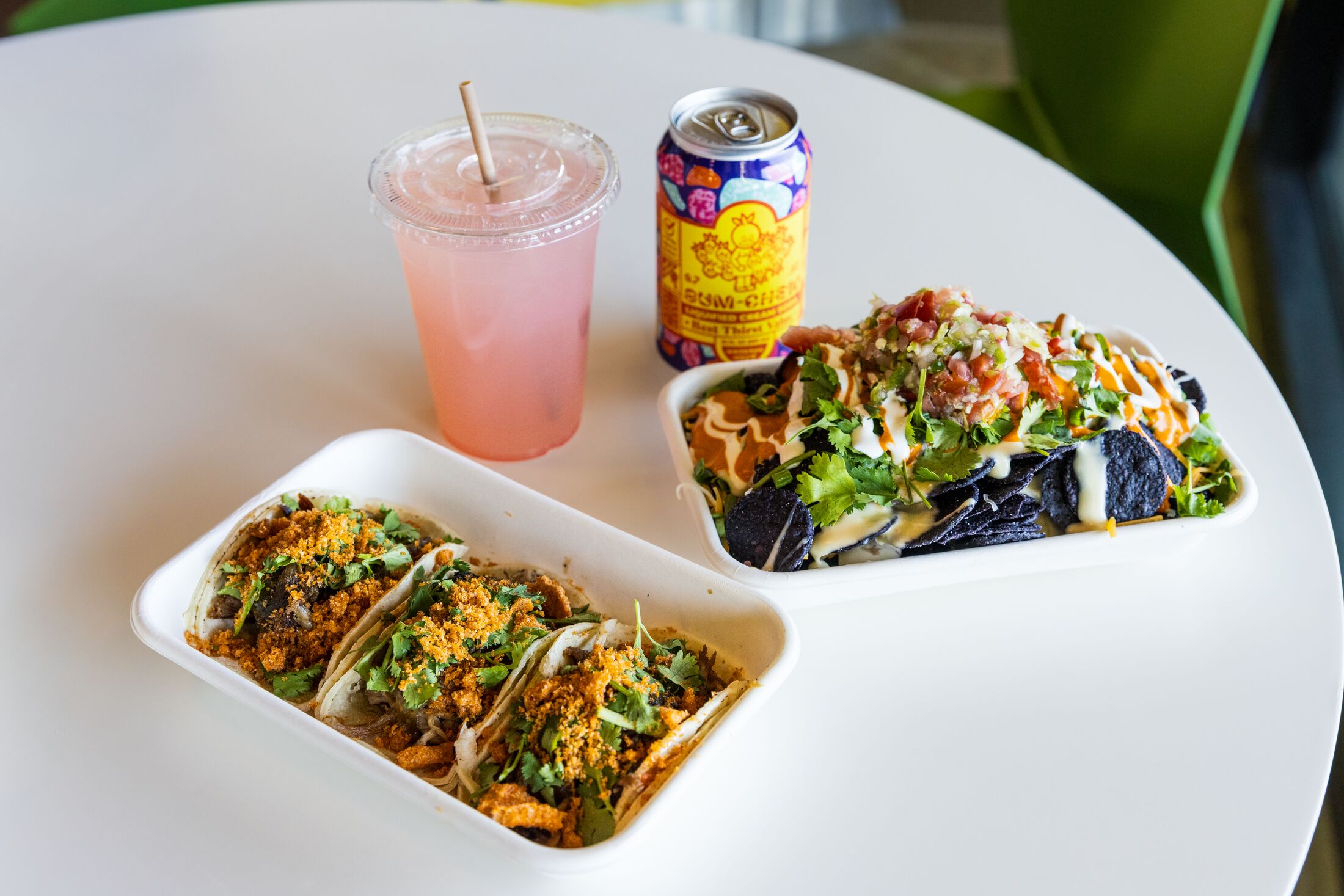 tacos and drinks on a white table