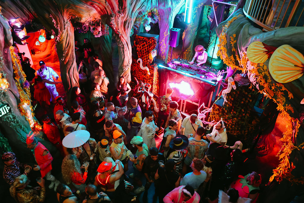 people dancing inside a forest-like space at Meow Wolf Denver