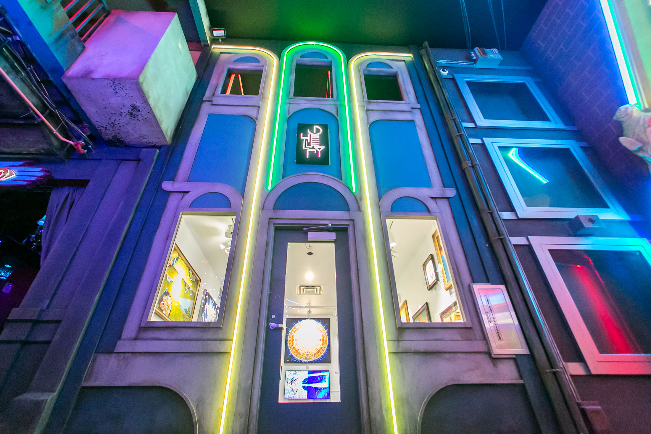 Galleri Gallery, a tall building with bright lights with rotating artwork exhibits inside