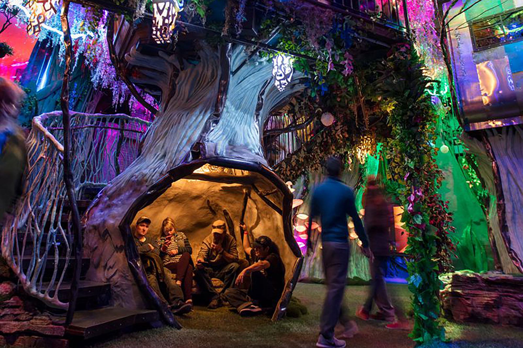 people walking through a forest inside Meow Wolf in Santa Fe