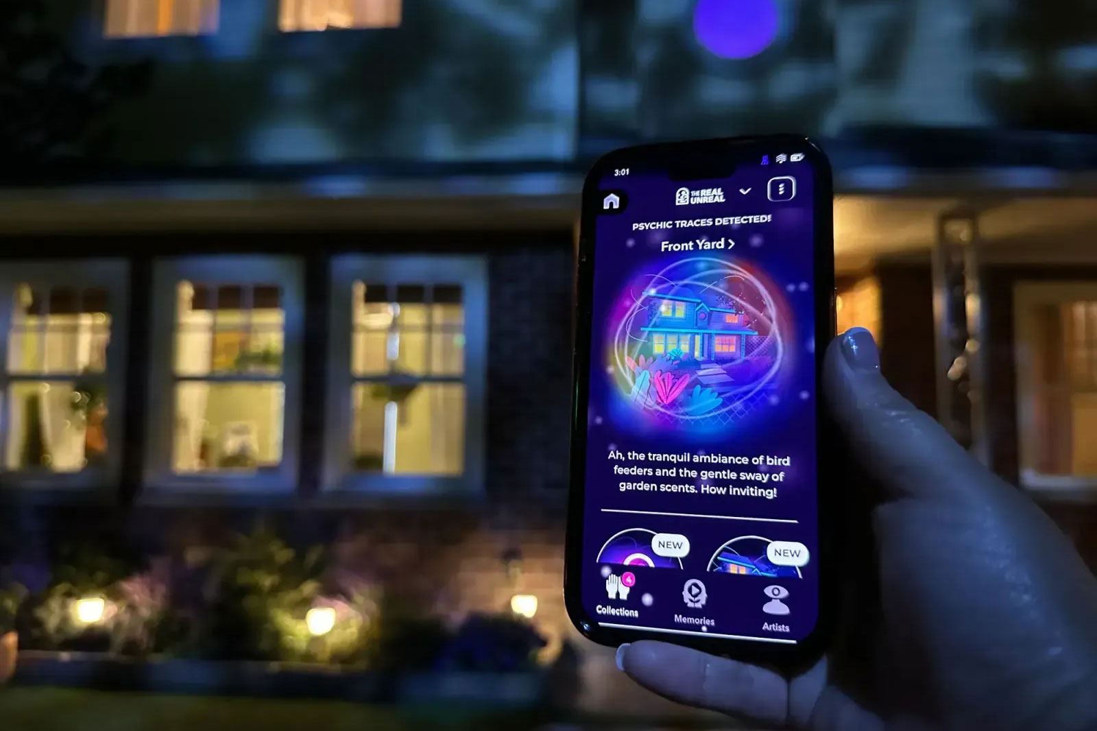 an app on a phone in front of a house at Meow Wolf