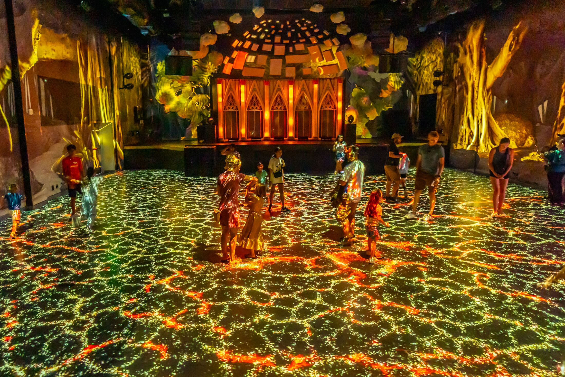 light and image projection on the floor and walls of a large event space