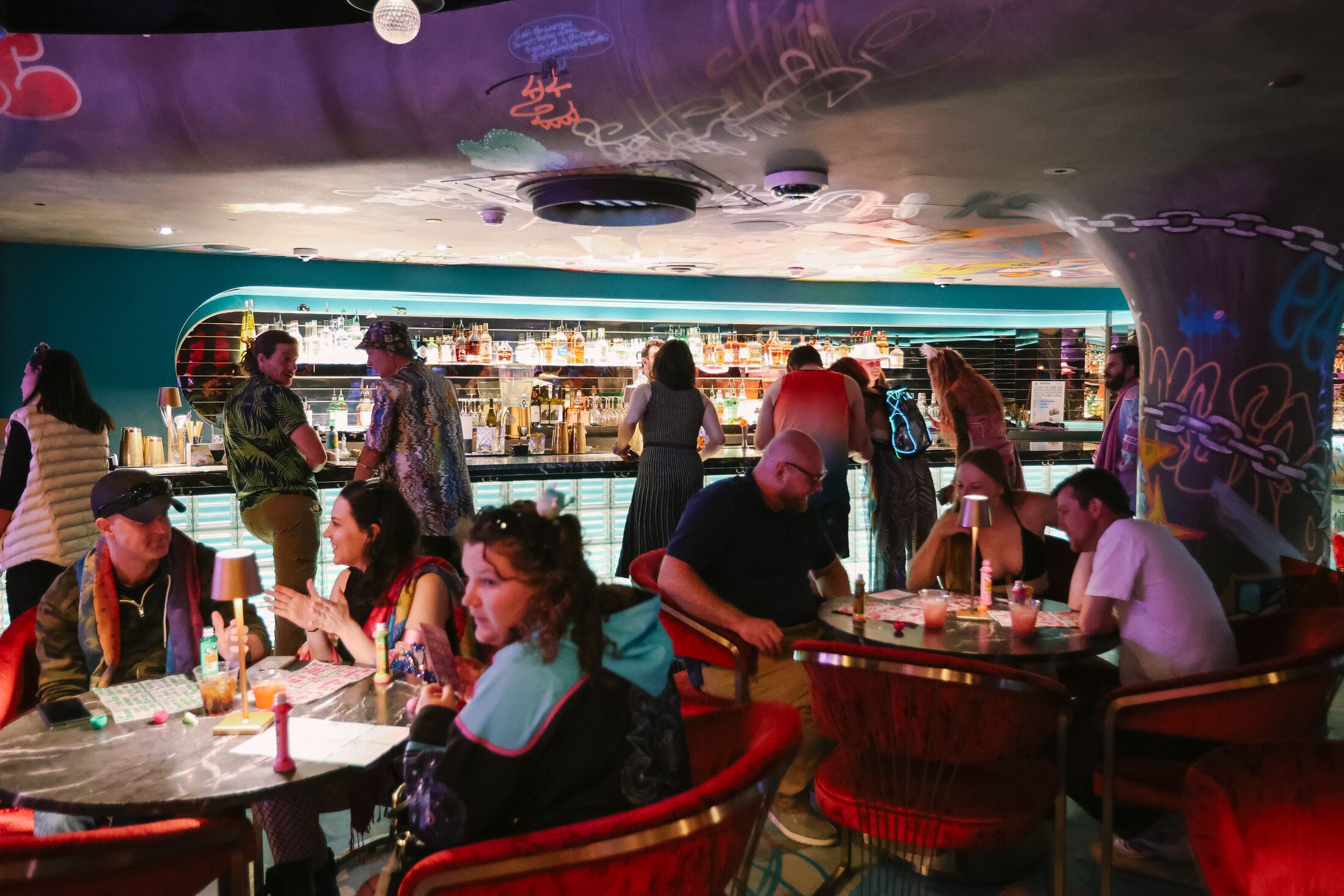 people talking and drinking inside a bar space at Meow Wolf