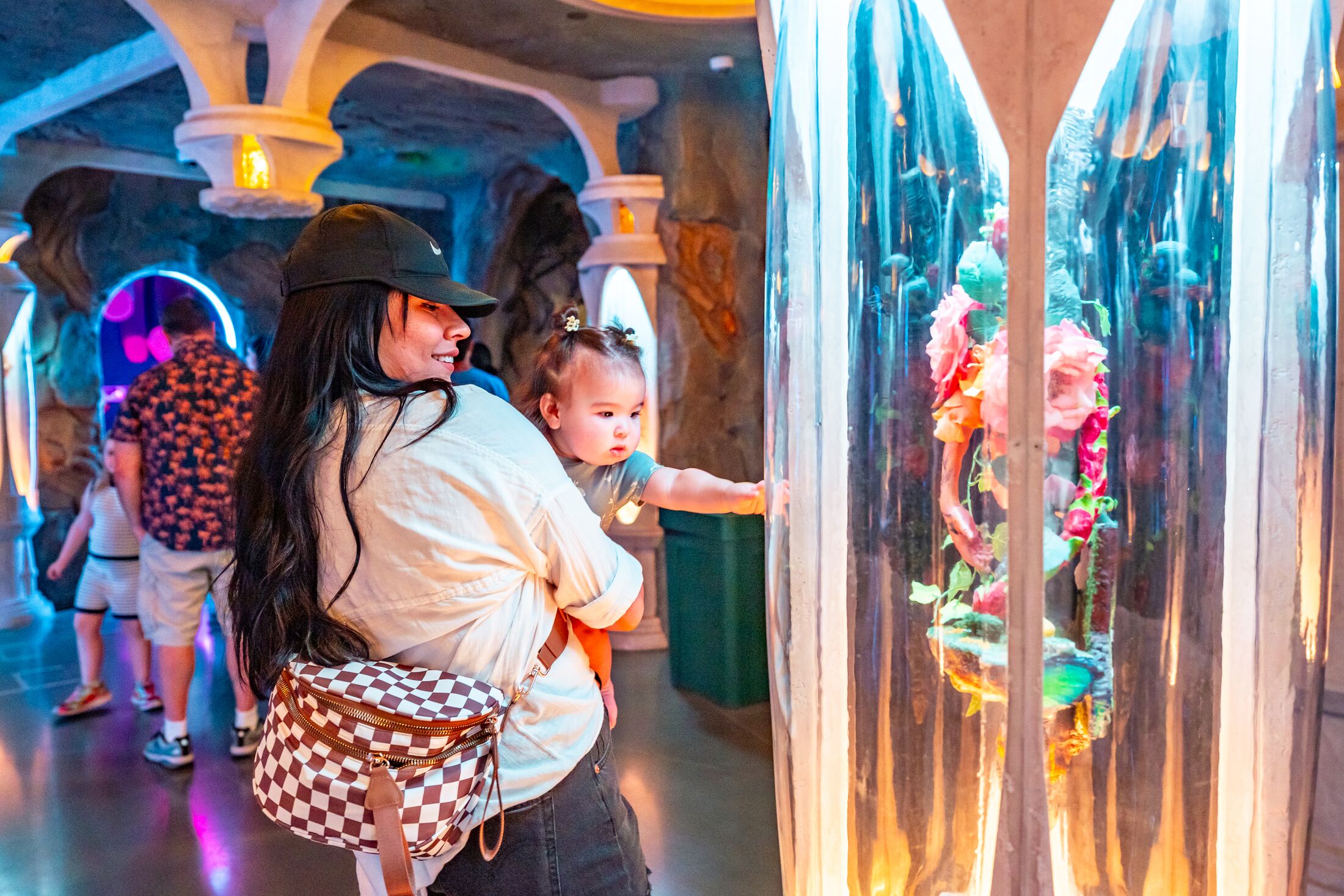 people inside a brightly lit former library filled with history of a world that existed before Meow Wolf Denver