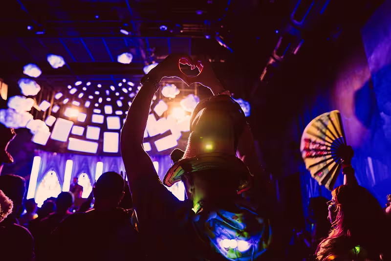 people dancing and interacting with light projections at Meow Wolf