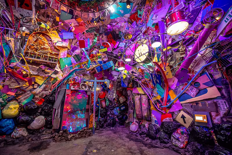 lots of recycled items turned into a giant music-making space at Meow Wolf Denver