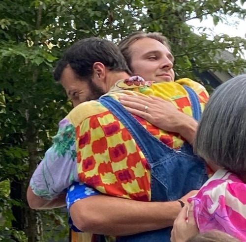 Two men embracing.