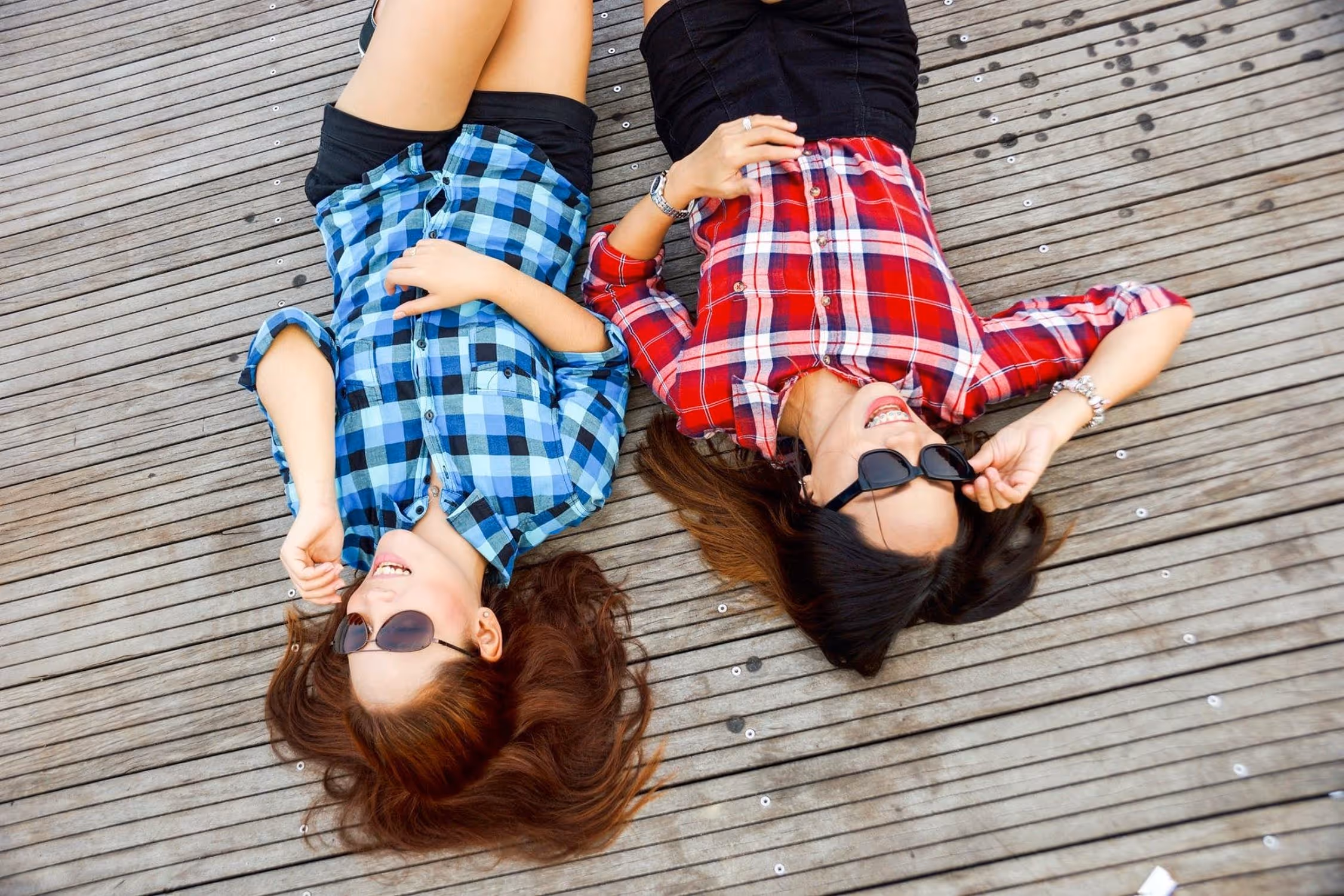 adult besties lying on a dock lol-ing about these relatable adult friendship memes