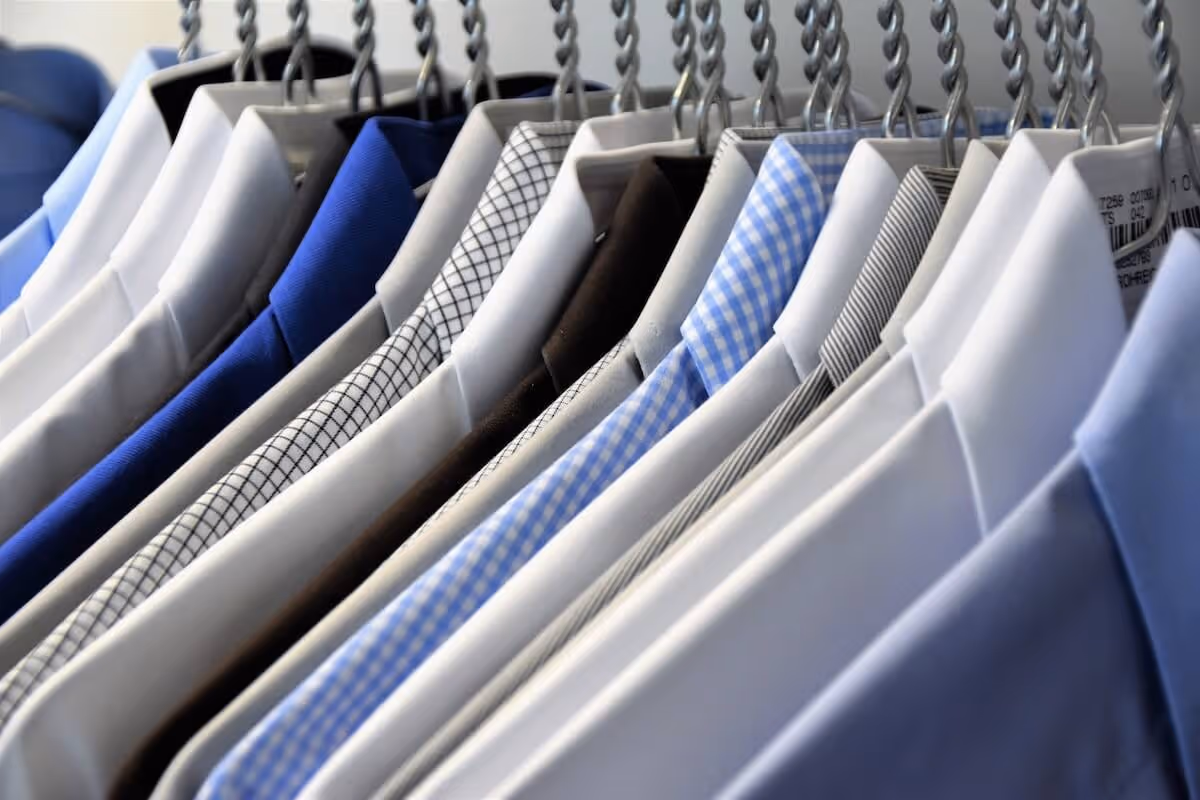 Mens dress shirts hanging on a rack