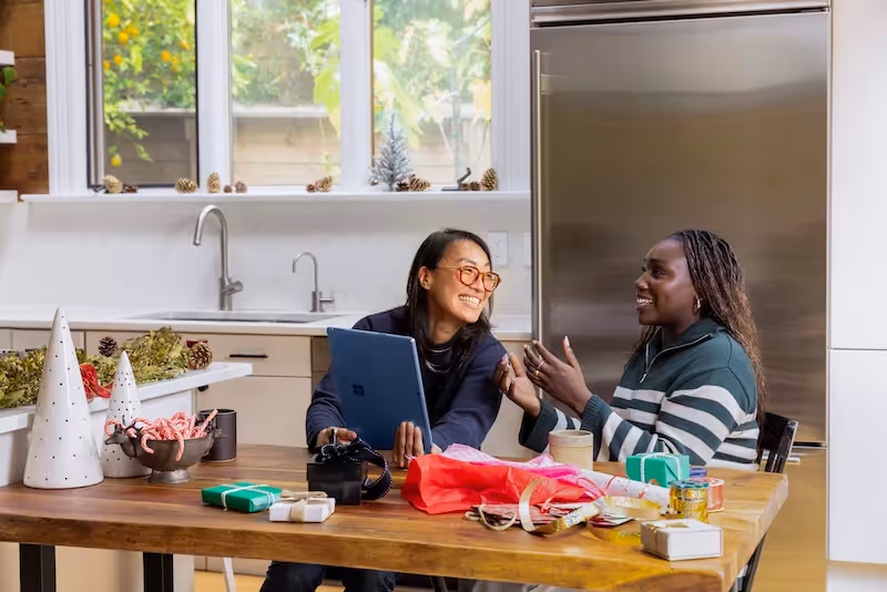 Two people sitting at a kitchen table