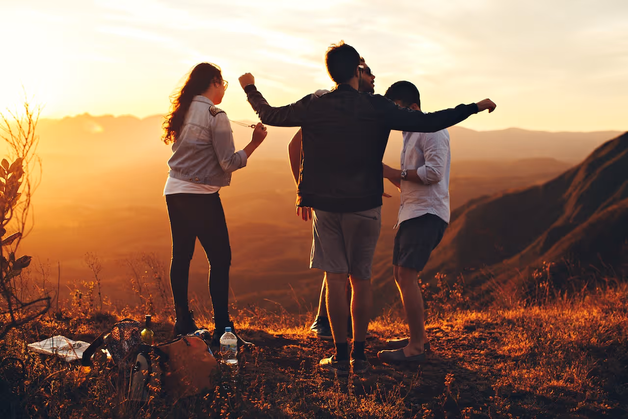 four college students on a sunset hike together
