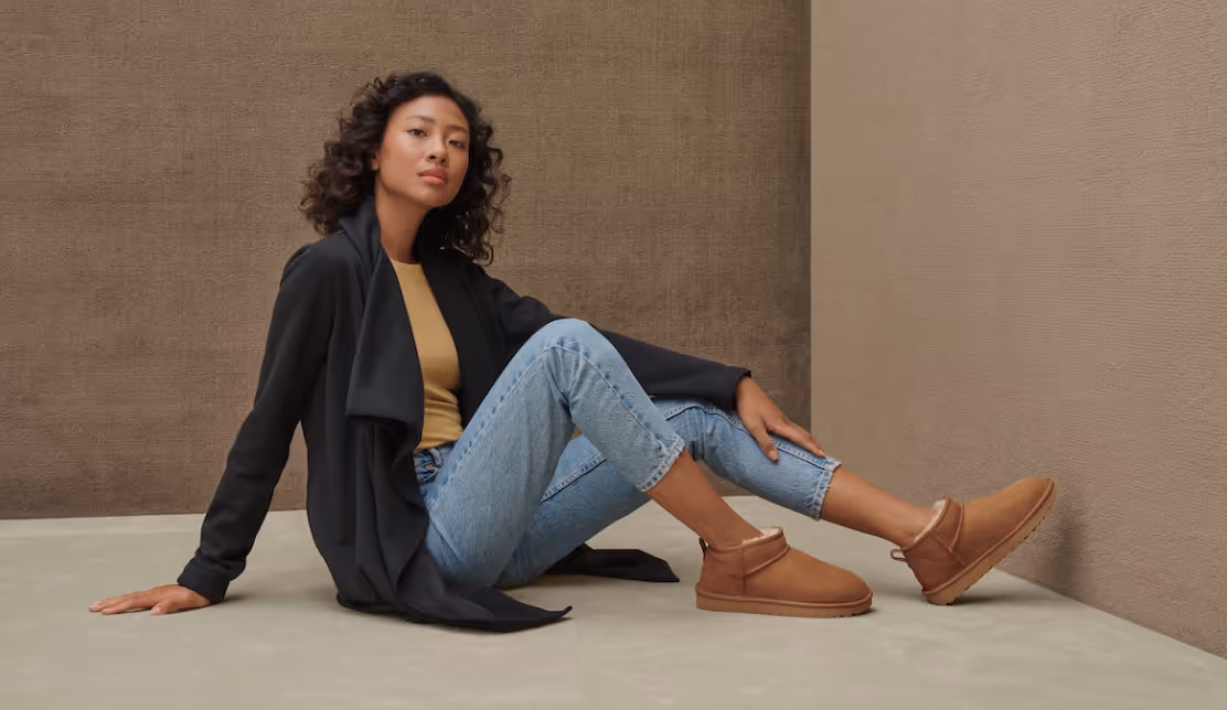 woman with curly hair modeling mini boots