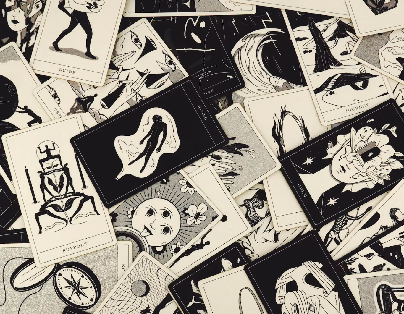 black and white indie Poesis oracle cards scattered in a pile